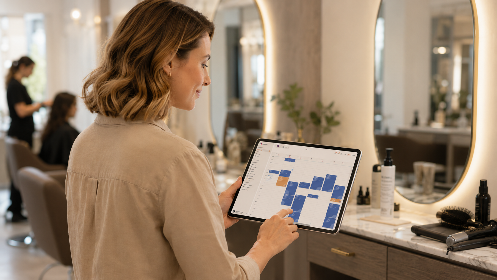 A salon manager using Saloninfra on a tablet